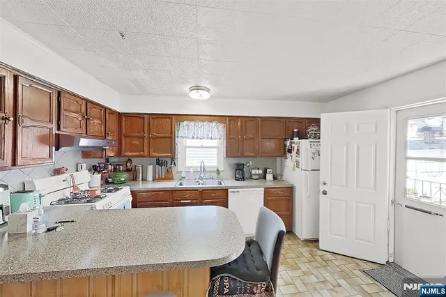 a living room with furniture and a dining table with wooden floor