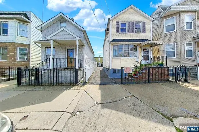a view of a brick house with many windows
