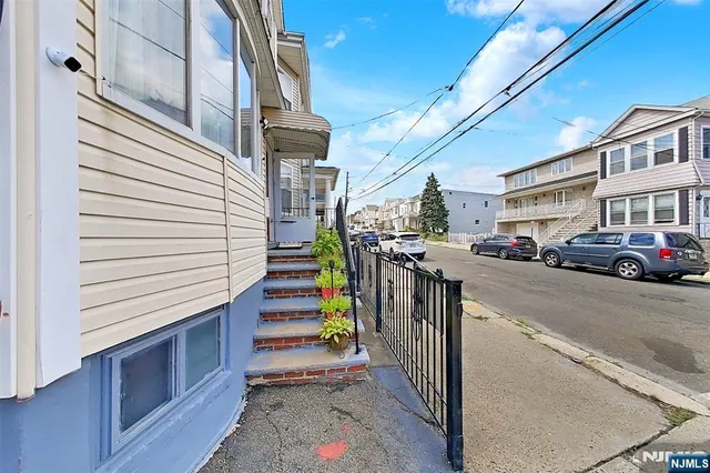 a view of a house with a yard and sitting area