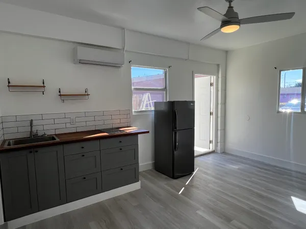 a kitchen with stainless steel appliances granite countertop a refrigerator a sink and dishwasher