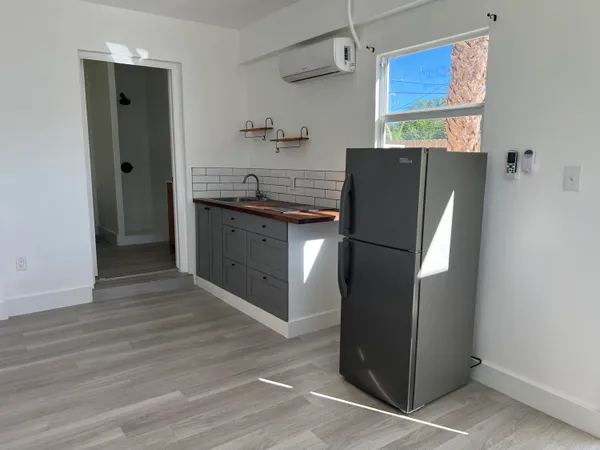 a kitchen with stainless steel appliances granite countertop a refrigerator and a sink