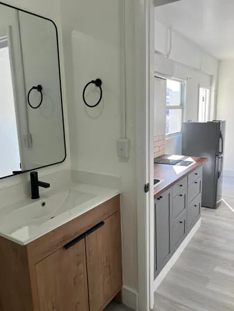 a bathroom with a double vanity sink mirror and tub