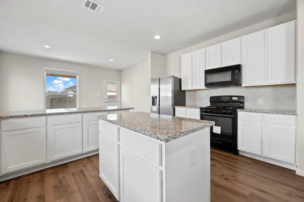 a kitchen with a sink stove and refrigerator
