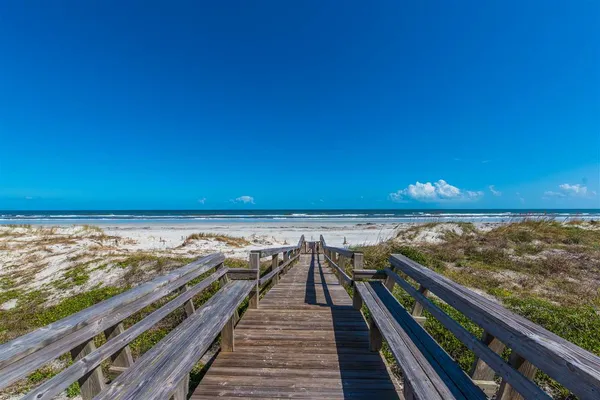 a view of a swimming pool and lounge chairs