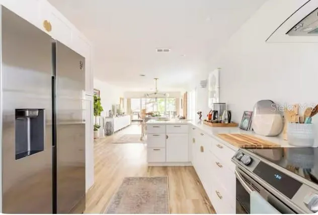 a kitchen with a sink stove and refrigerator