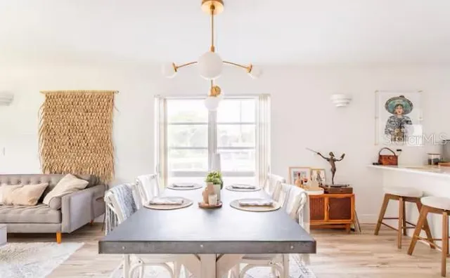 a kitchen with granite countertop a sink cabinets and wooden floor