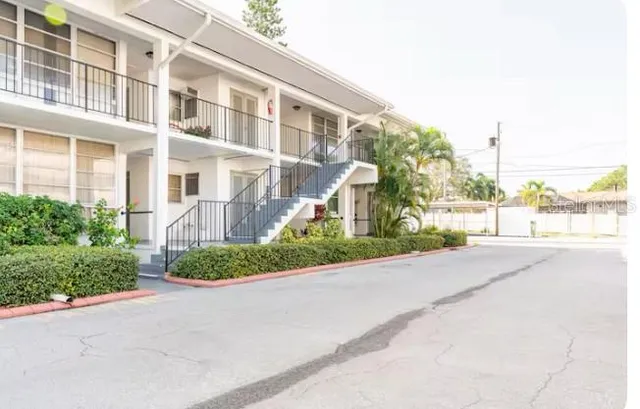 a view of a street with a building in the background