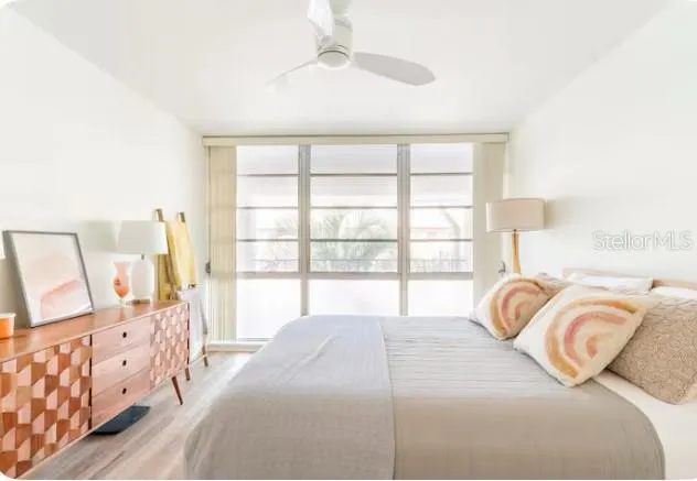 a view of a bedroom with a bed and a window