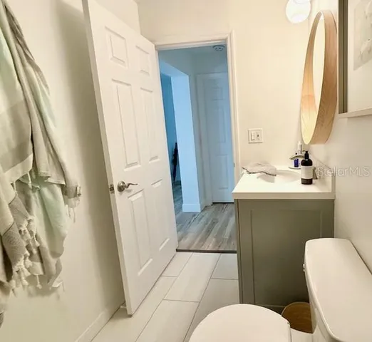 a view of a kitchen with kitchen island and stainless steel appliances