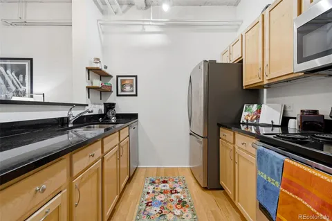 a kitchen with stainless steel appliances granite countertop a stove and a sink