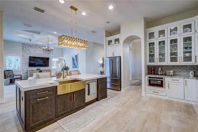 a large kitchen with a center island and stainless steel appliances