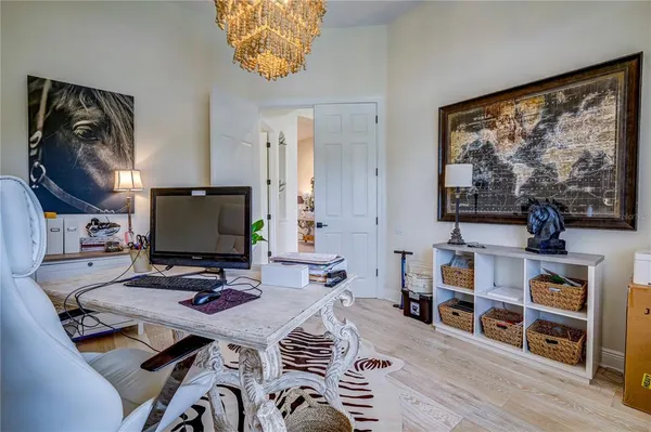 a view of a workspace with furniture and a flat screen tv