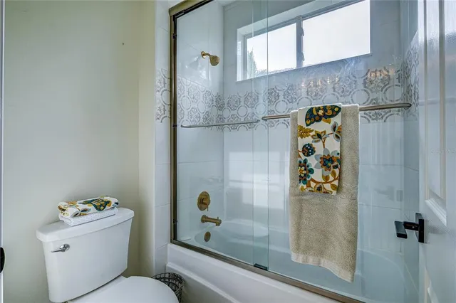 a bathroom with a shower and a toilet