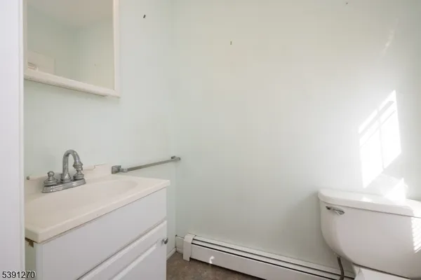 a bathroom with a sink toilet and a mirror