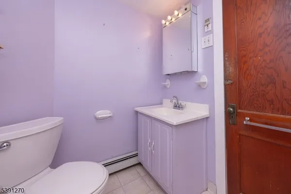 a bathroom with a sink a toilet a mirror and vanity
