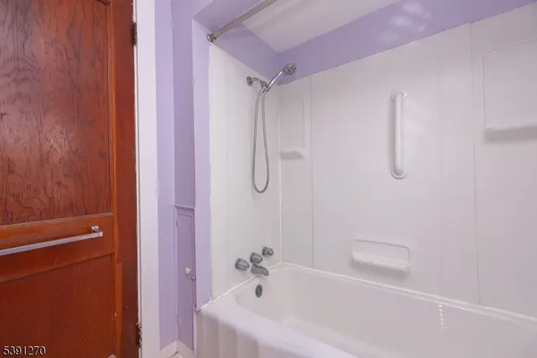 a bath room with a shower and a bath tub
