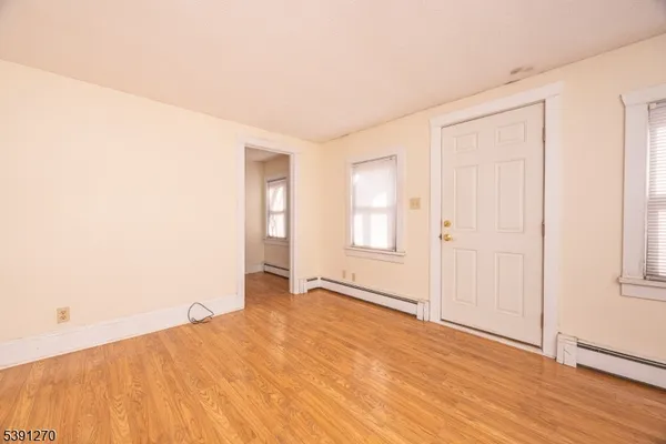 a view of an empty room and wooden floor