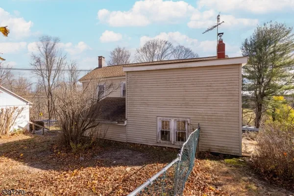 a side view of a house with a yard