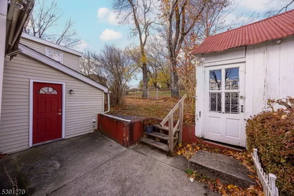 a view of backyard with deck and outdoor seating