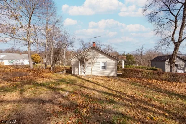a view of a house with a yard covered in snow