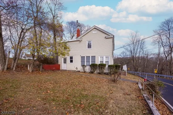 a view of a house with a yard patio and fire pit