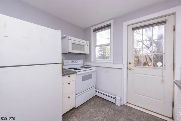 a kitchen with a stove a sink and a window