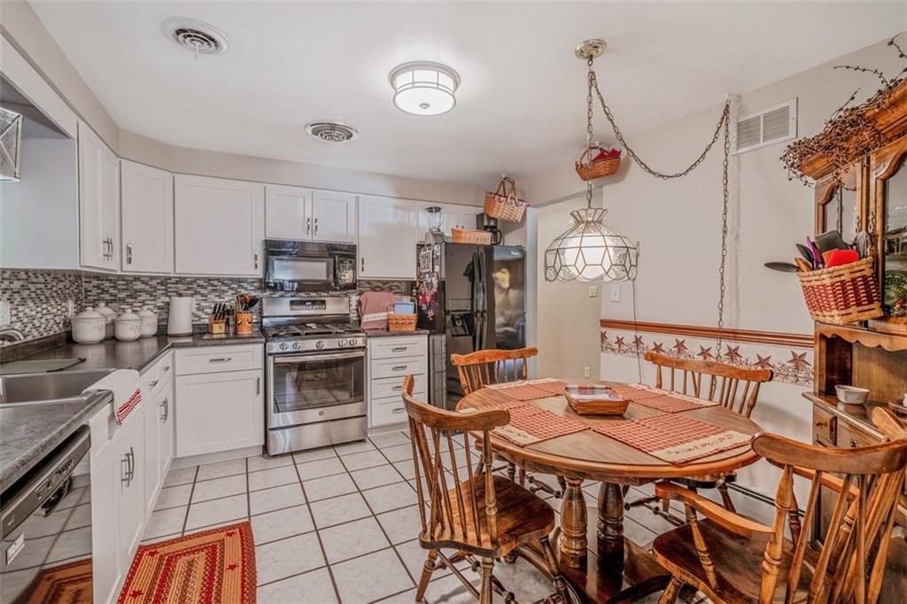 2668 Pangburn Hollow Road Monongahela, PA 15063 - Photo 9 of 44 a kitchen with stainless steel appliances a table chairs and a refrigerator