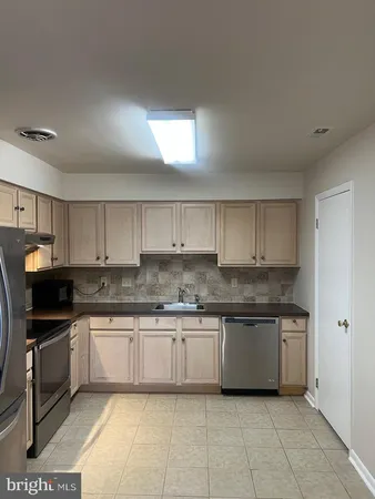a kitchen with stainless steel appliances granite countertop a sink and cabinets