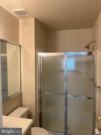 a bathroom with a shower and a toilet