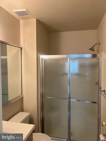 a bathroom with a shower and a toilet