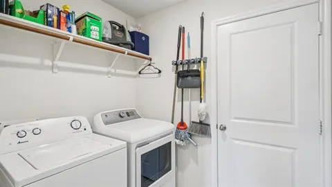 a bedroom with a bed and a wall painting