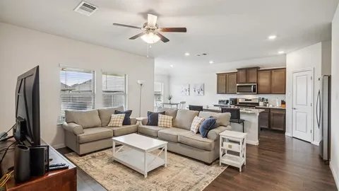 a living room with fireplace furniture and a flat screen tv