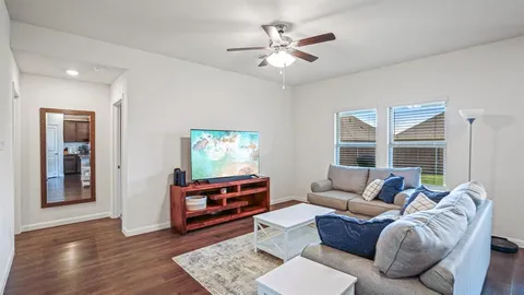 a living room with furniture and windows