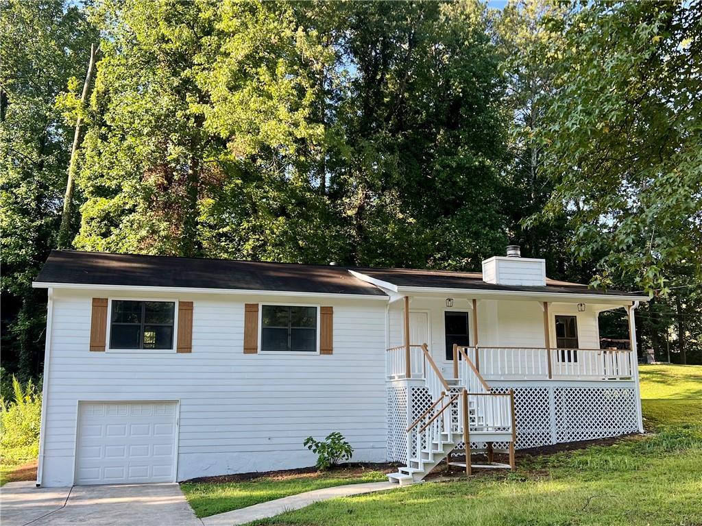 a front view of house with yard and green space