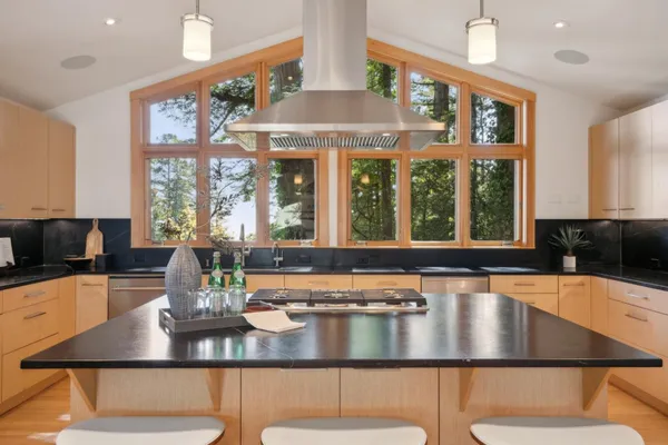 a kitchen with a table chairs and window