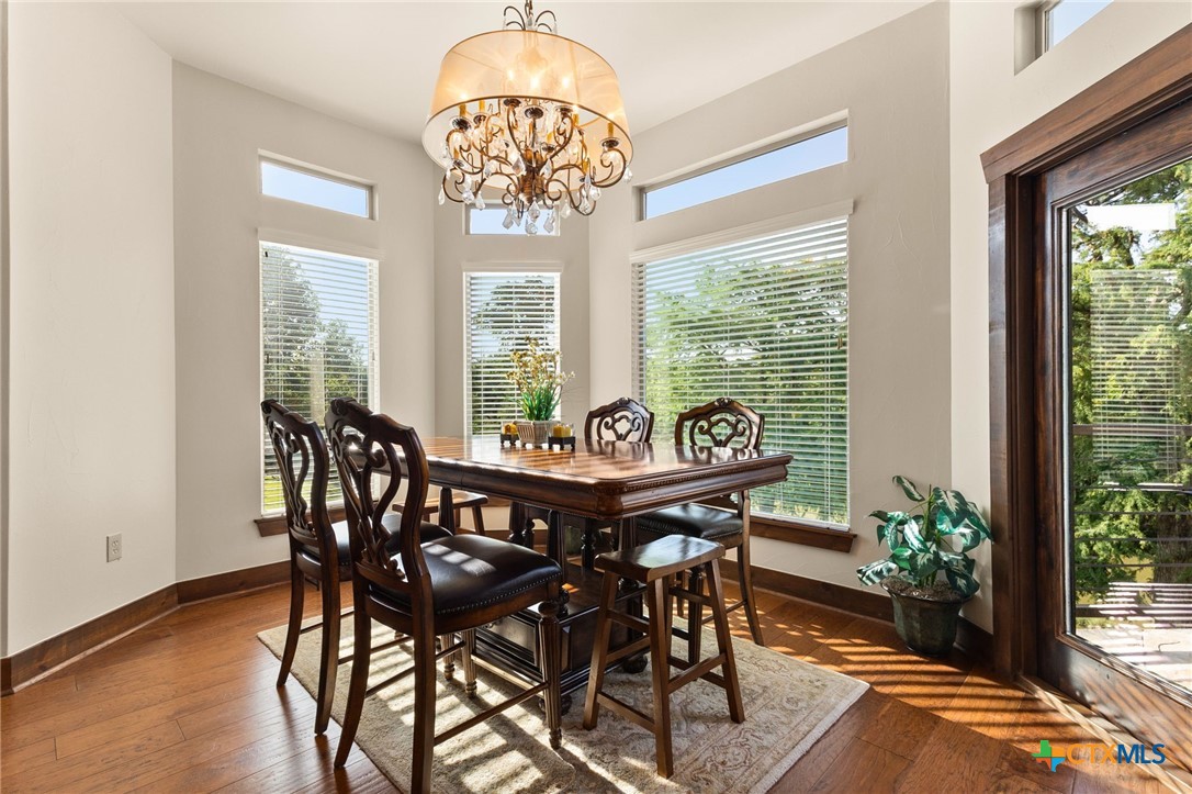 134 Bandit Beach Road New Braunfels, TX 78130 - Photo 13 of 46 a view of a dining room with furniture window and wooden floor