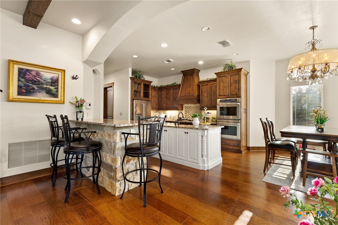 134 Bandit Beach Road New Braunfels, TX 78130 - Photo 14 of 46 a view of a dining room with furniture and wooden floor