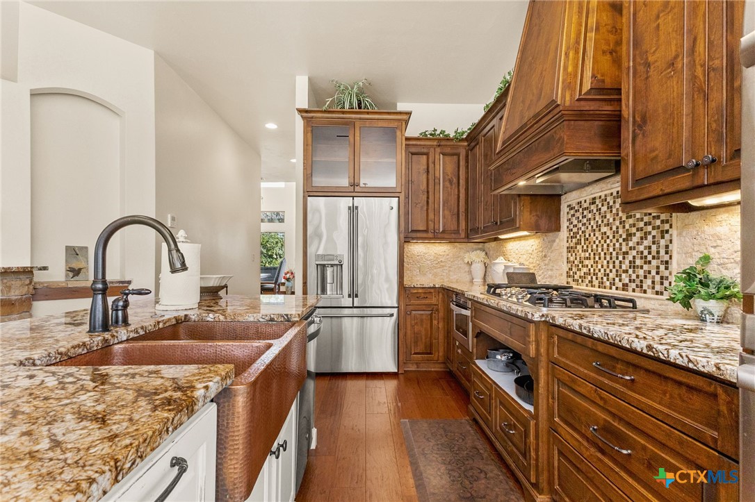 134 Bandit Beach Road New Braunfels, TX 78130 - Photo 16 of 46 a kitchen with stainless steel appliances granite countertop a sink stove and refrigerator