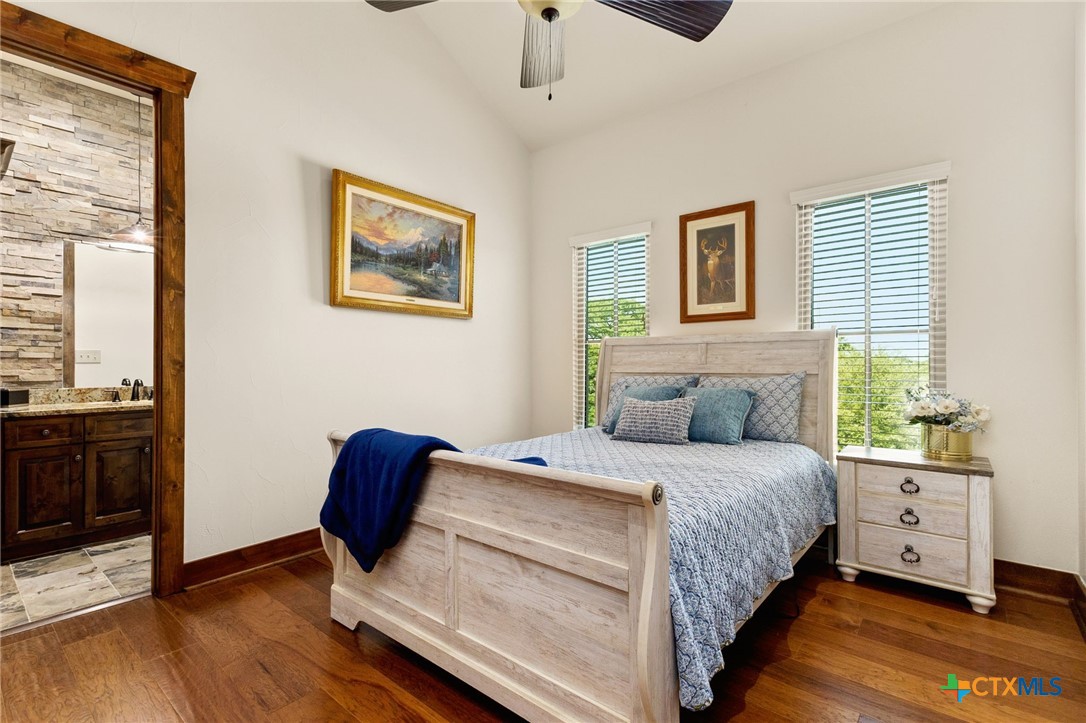 134 Bandit Beach Road New Braunfels, TX 78130 - Photo 31 of 46 a bedroom with a bed and wooden floor