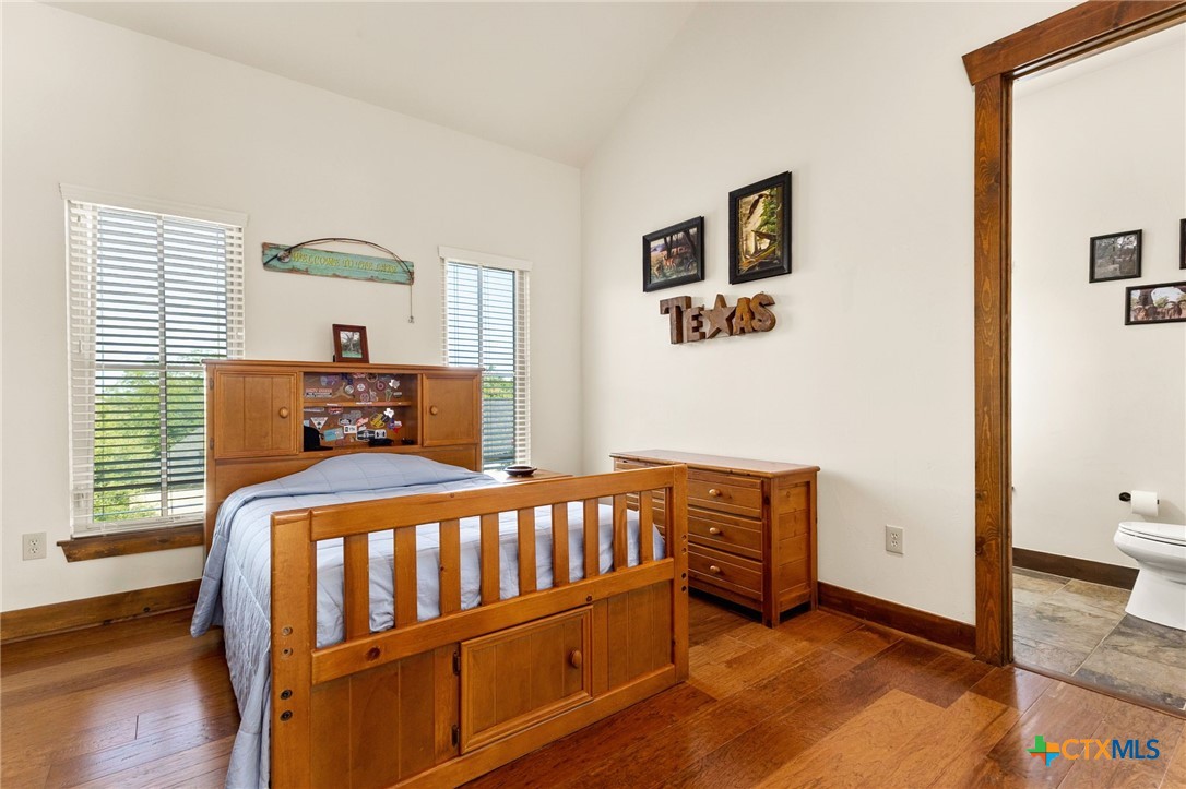 134 Bandit Beach Road New Braunfels, TX 78130 - Photo 33 of 46 a bedroom with a bed and wooden floor