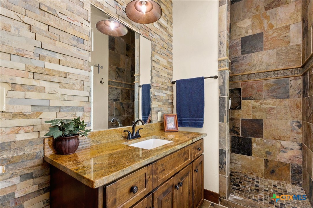 134 Bandit Beach Road New Braunfels, TX 78130 - Photo 34 of 46 a bathroom with a sink and a mirror