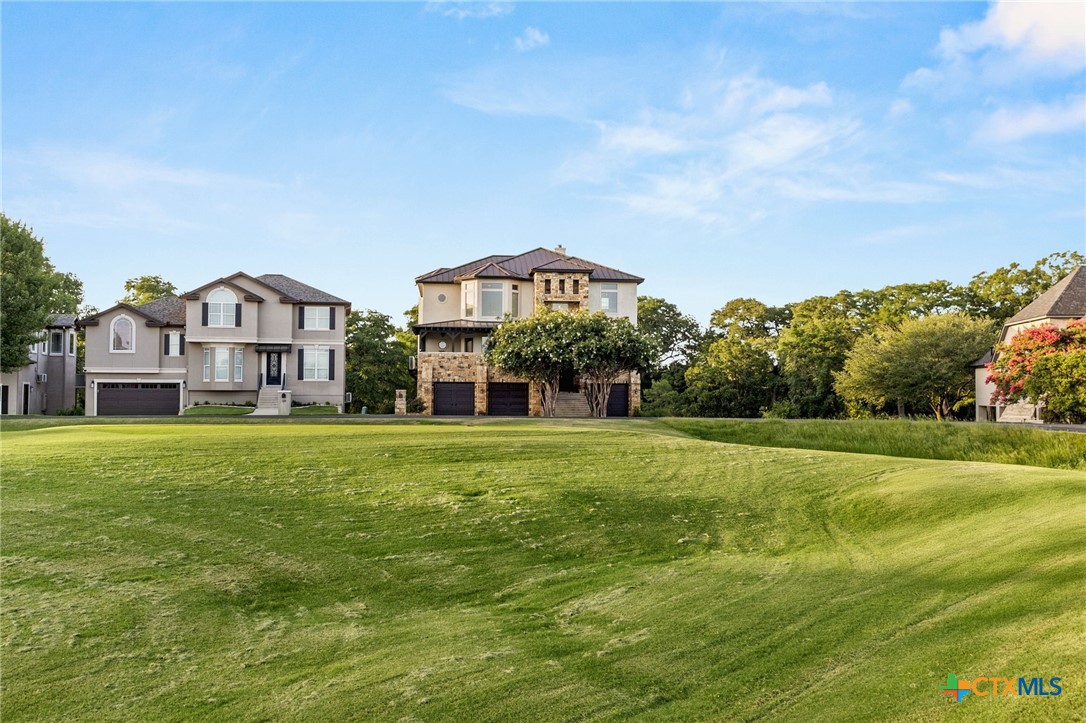 134 Bandit Beach Road New Braunfels, TX 78130 - Photo 43 of 46 a view of a big house with a big yard and large trees