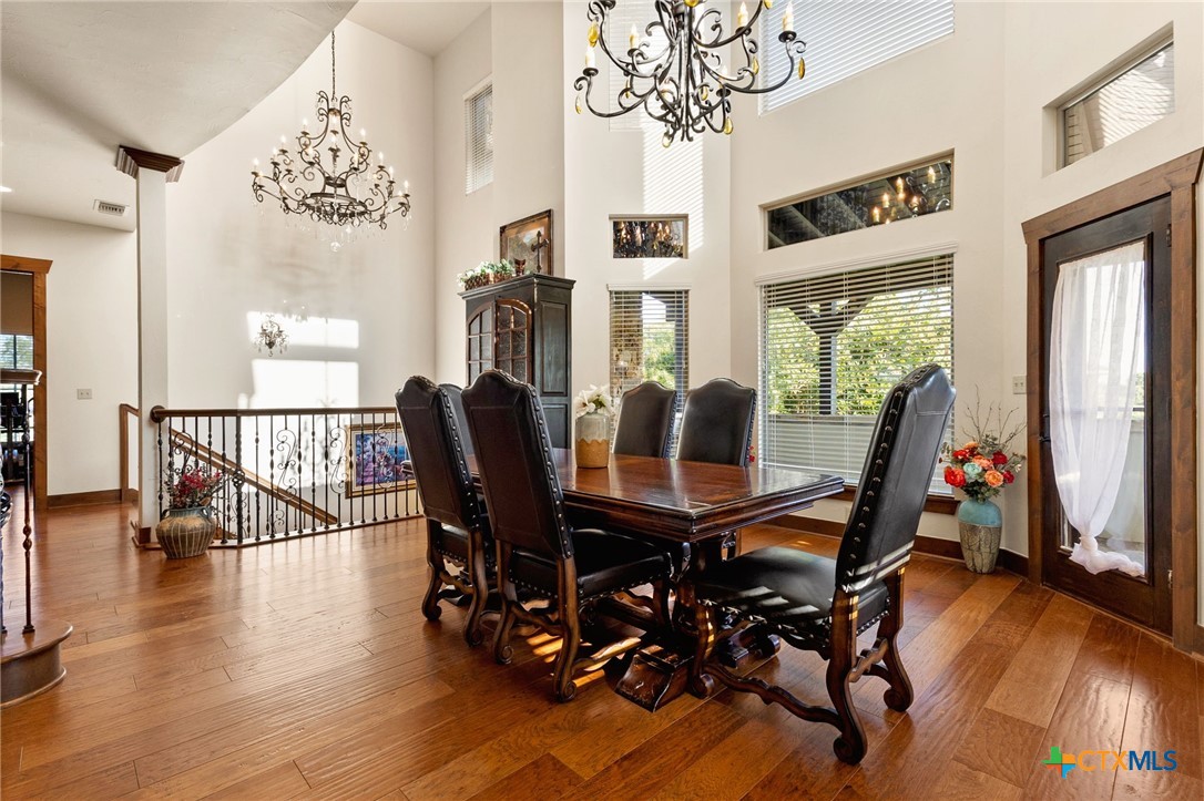 134 Bandit Beach Road New Braunfels, TX 78130 - Photo 5 of 46 a view of a dining room with furniture window and wooden floor