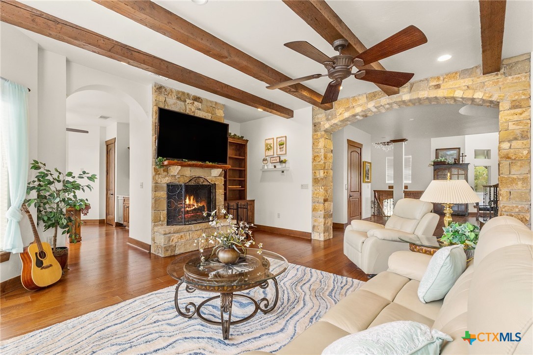134 Bandit Beach Road New Braunfels, TX 78130 - Photo 9 of 46 a living room with furniture a fireplace and a flat screen tv