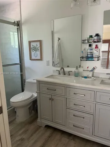 a bathroom with a toilet sink and mirror