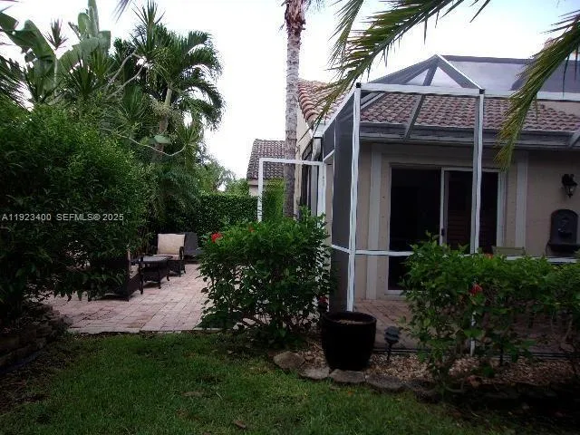 a view of a house with a yard and plants