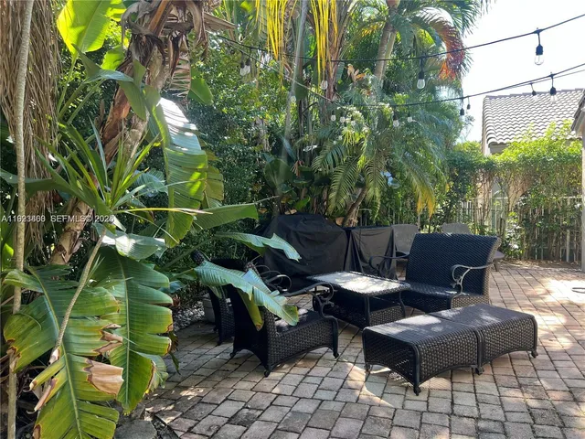 a view of a chairs and table in a backyard