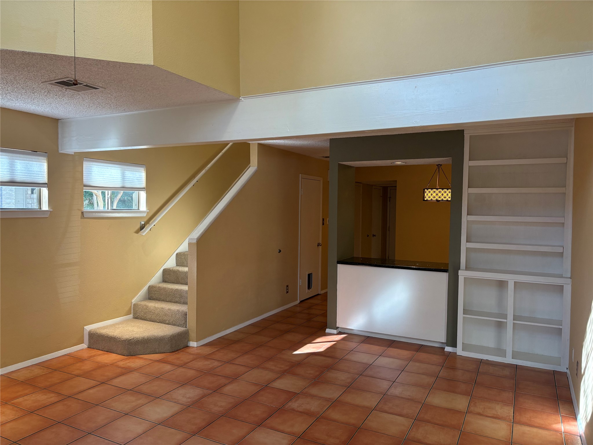 9226 Jollyville Road, Unit 144 Austin, TX 78759 - Photo 5 of 40 Basement with a textured ceiling, stairs, and light tile patterned flooring