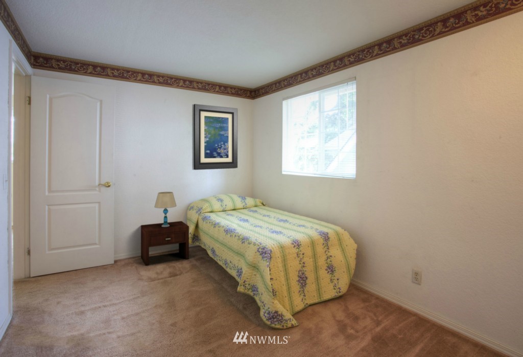 2517 166th Place Southeast Bothell, WA 98012 - Photo 13 of 20 a spacious bedroom with a bed and a window