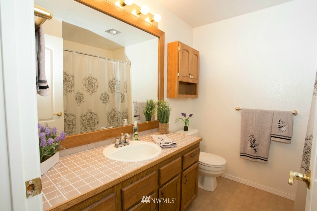 2517 166th Place Southeast Bothell, WA 98012 - Photo 15 of 20 a bathroom with a granite countertop sink toilet and shower